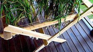 This homemade drying rack allows garlic or herbs to hang and nutrients from stalks to be absorbed